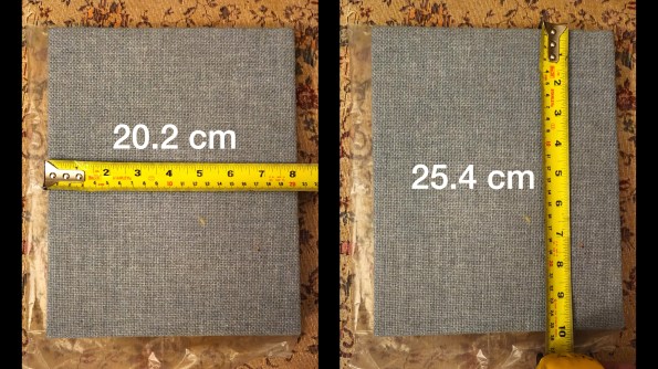 Rectangular cloth covered fiberglass panel shown under tape measure
